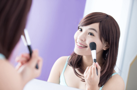 Smile woman with makeup brushes